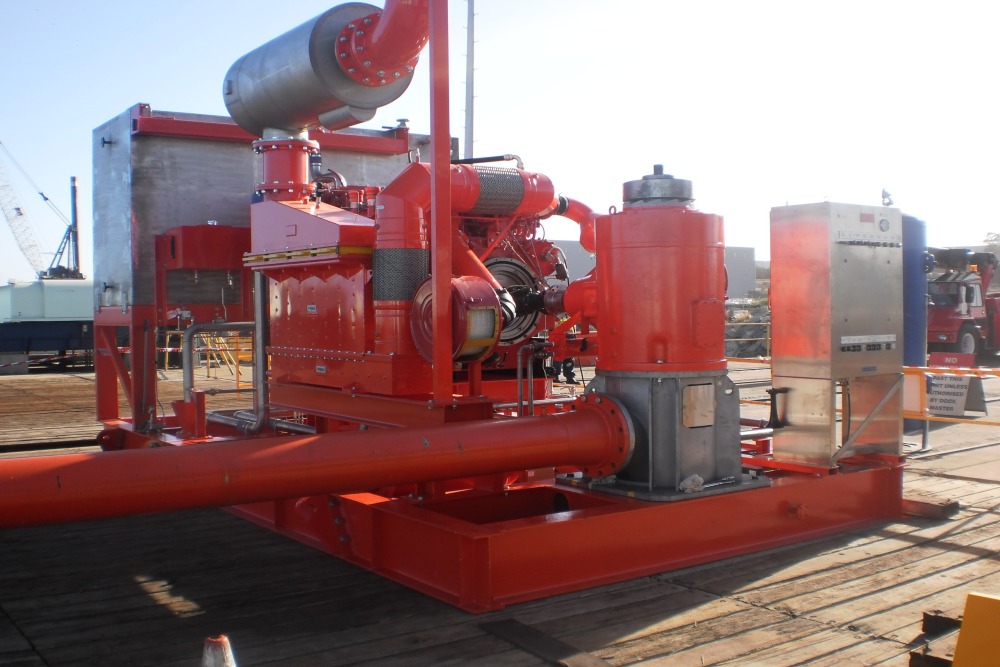 Large industrial engine with fire pump and piping on a skid ready for transport to a Oil & Gas rig